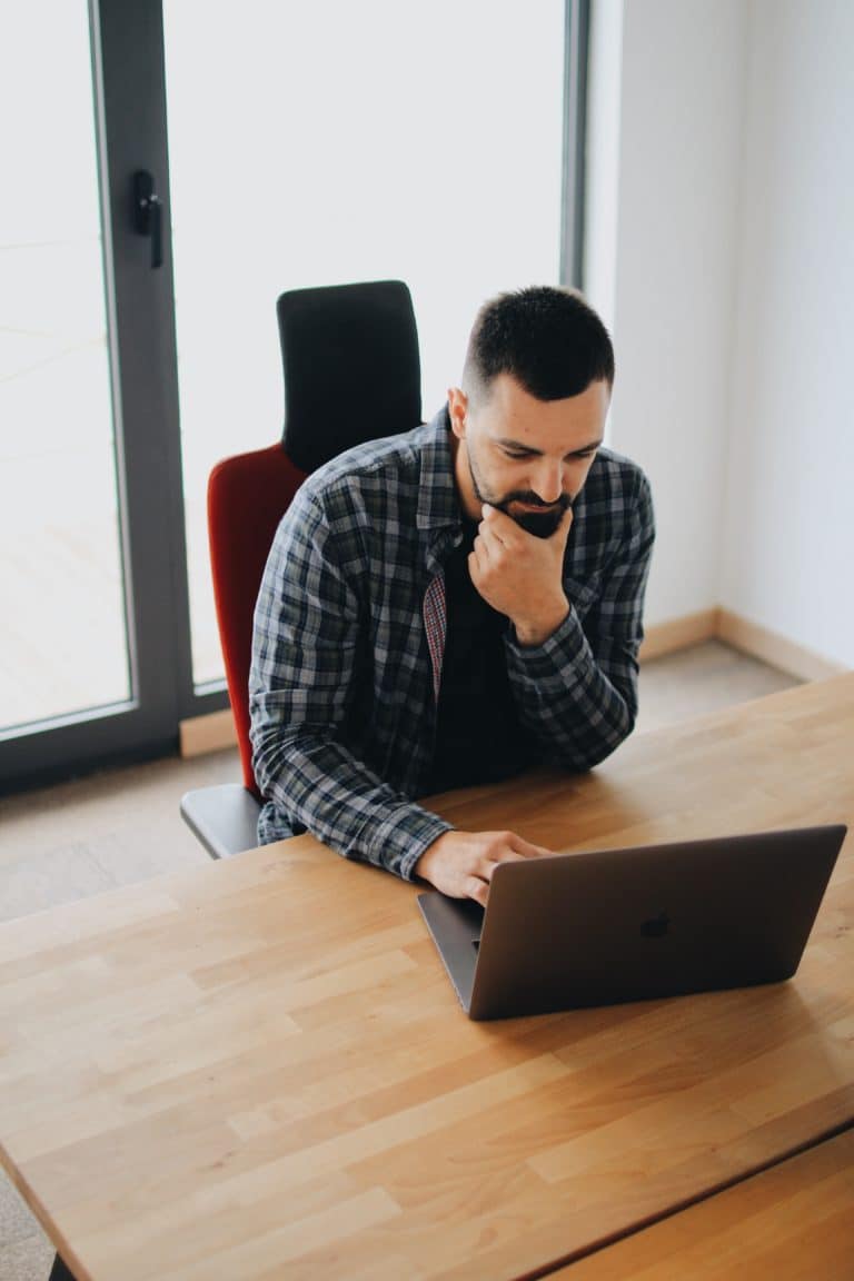 Image of a man at his desk reviewing pre-recorded webinars